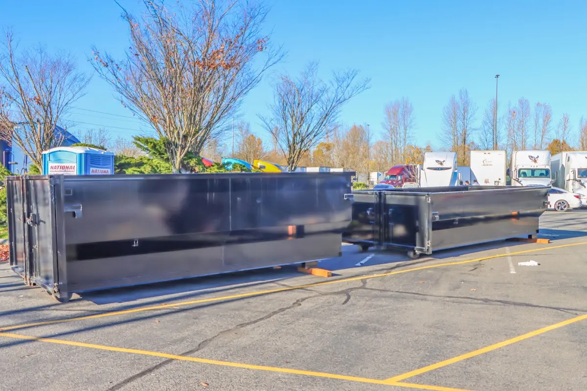 Professional dumpster rental service with roll-off container on residential driveway in Huntington Beach